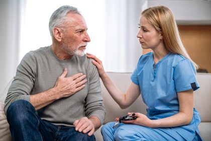 General practitioner and senior patient talking about heartache