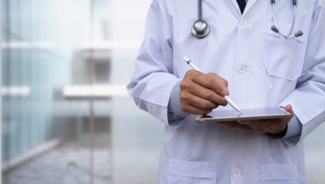 Doctro using digital tablet in hospital